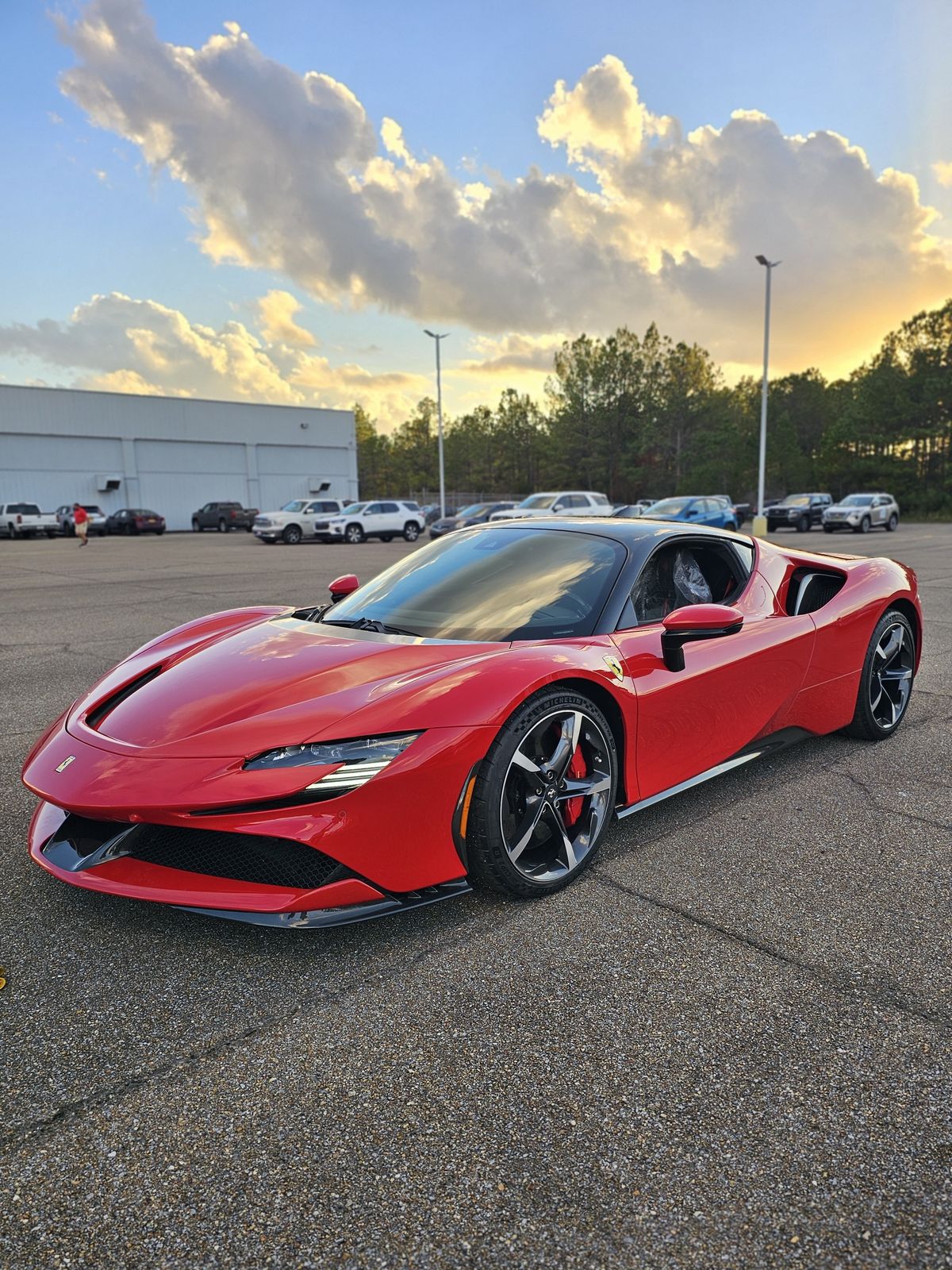 Red Ferrari SF90 at sunset