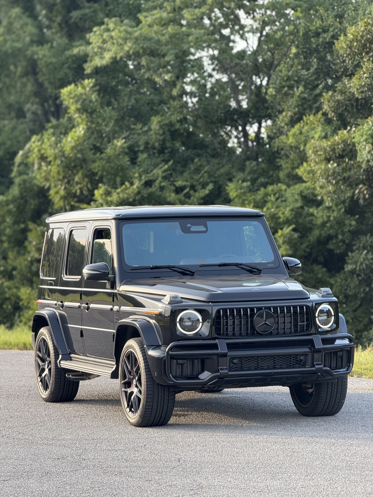 Black Mercedes-AMG G63 on a forest road